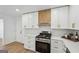 Kitchen featuring stainless steel appliances, quartz countertops, white cabinets with brass hardware at 3939 Hamilton Mill Rd, Buford, GA 30519