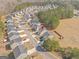 Aerial view of a home in a suburban neighborhood with fenced backyard and proximity to the wooded area at 151 Brasch Park Dr, Grantville, GA 30220