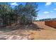 Grassy backyard with a patio and treeline at 151 Brasch Park Dr, Grantville, GA 30220