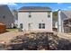 Backyard featuring a patio, grassy lawn, and views of neighboring homes and mature trees, perfect for outdoor living at 151 Brasch Park Dr, Grantville, GA 30220