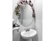 Elegant half bathroom features a decorative mirror and pedestal sink at 151 Brasch Park Dr, Grantville, GA 30220
