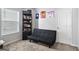 Spare bedroom features a futon, carpet flooring and a window at 151 Brasch Park Dr, Grantville, GA 30220
