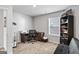 Neutral bedroom featuring a desk, bookshelf, black futon, and a sunlit window, perfect for a home office at 151 Brasch Park Dr, Grantville, GA 30220