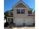 Charming two-story home with a two-car garage and neutral colored siding and brick at 151 Brasch Park Dr, Grantville, GA 30220