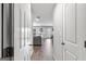 Hallway with white doors and light wood floors leading to a bright living area at 151 Brasch Park Dr, Grantville, GA 30220