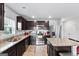 Modern kitchen featuring stainless steel appliances, granite countertops, and dark brown cabinetry at 151 Brasch Park Dr, Grantville, GA 30220