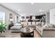 Cozy living room featuring a gray sectional sofa and an open floor plan to the kitchen at 151 Brasch Park Dr, Grantville, GA 30220