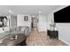 Inviting living room featuring a comfortable gray sofa, wood floors, and a large flat-screen television at 151 Brasch Park Dr, Grantville, GA 30220