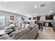 Spacious living room with modern furniture, open layout, and views of the dining and kitchen areas at 151 Brasch Park Dr, Grantville, GA 30220
