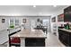 Open concept living room area connected to the kitchen and dining space featuring an island with granite countertop at 151 Brasch Park Dr, Grantville, GA 30220