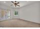 Spacious bedroom featuring a ceiling fan, large window, and access to a private balcony at 535 Waters Way, Fayetteville, GA 30215