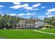 Large home with pond in the front yard reflected beautifully in the still water on a bright sunny day with blue sky and green trees at 535 Waters Way, Fayetteville, GA 30215