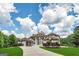 Stately home with fountain and long driveway, set against a beautiful sky, showcasing grandeur at 535 Waters Way, Fayetteville, GA 30215