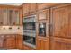 Kitchen features stainless steel appliances, double ovens and rich wood cabinetry at 535 Waters Way, Fayetteville, GA 30215