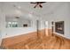 Spacious living room featuring hardwood floors, two fireplaces, and a large mirror reflecting natural light from the outside at 535 Waters Way, Fayetteville, GA 30215