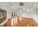 Elegant living room boasts a fireplace, hardwood floors, tray ceilings, and French doors leading to a balcony with views at 535 Waters Way, Fayetteville, GA 30215