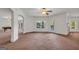 Spacious living room featuring a ceiling fan and seamless access to the outdoor pool area at 535 Waters Way, Fayetteville, GA 30215