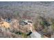 Aerial view of home, pool, detached garage, and wooded area at 130 Seneca Pl, Fayetteville, GA 30215