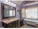 Bathroom boasts a clawfoot tub, walk-in shower, and granite countertop at 130 Seneca Pl, Fayetteville, GA 30215