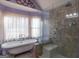 Bathroom with a clawfoot tub and a walk-in shower at 130 Seneca Pl, Fayetteville, GA 30215