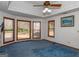 Spacious bedroom with large windows, wall-to-wall carpeting, and a ceiling fan at 130 Seneca Pl, Fayetteville, GA 30215