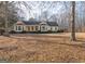 Ranch style home with large yard, covered porch, and mature trees at 130 Seneca Pl, Fayetteville, GA 30215
