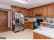 Kitchen features wood cabinets, stainless steel appliances, and ample counter space at 130 Seneca Pl, Fayetteville, GA 30215