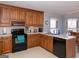 Kitchen with wood cabinets, black appliances, and breakfast nook at 130 Seneca Pl, Fayetteville, GA 30215