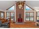 Living room features a brick fireplace, wood floors, and a view of the pool at 130 Seneca Pl, Fayetteville, GA 30215