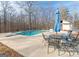 Relaxing pool area with patio furniture and umbrella at 130 Seneca Pl, Fayetteville, GA 30215