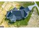 Aerial view highlighting the back of a home with a covered patio and chimney at 1291 Pleasant Grove Church Rd, Villa Rica, GA 30180