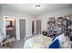 Well-lit bedroom with an antique-style bed and floral bedding, and an ensuite bathroom at 1291 Pleasant Grove Church Rd, Villa Rica, GA 30180