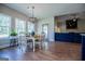 Bright dining area with hardwood floors and a farmhouse-style table, adjacent to the kitchen at 1291 Pleasant Grove Church Rd, Villa Rica, GA 30180