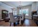 Farmhouse style dining room with chandelier, large windows and rustic table at 1291 Pleasant Grove Church Rd, Villa Rica, GA 30180