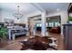Open concept dining room with rustic table, hardwood floors, and living room view at 1291 Pleasant Grove Church Rd, Villa Rica, GA 30180
