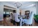 Spacious dining area with farmhouse table, chandelier and view of living room at 1291 Pleasant Grove Church Rd, Villa Rica, GA 30180