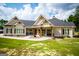Tan house with a wraparound porch and stone accents at 1291 Pleasant Grove Church Rd, Villa Rica, GA 30180