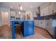 Modern kitchen with a large island, stainless steel appliances, and blue cabinetry at 1291 Pleasant Grove Church Rd, Villa Rica, GA 30180