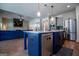 Modern kitchen with stainless steel appliances and a large blue island, open to the living room at 1291 Pleasant Grove Church Rd, Villa Rica, GA 30180