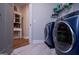 Bright laundry room with washer, dryer and built-in storage at 1291 Pleasant Grove Church Rd, Villa Rica, GA 30180