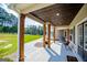 Relaxing covered porch with wooden columns and a view of the backyard at 1291 Pleasant Grove Church Rd, Villa Rica, GA 30180