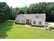 Aerial view showcasing the house's setting on a spacious lot with lush landscaping at 2204 Happy Hollow Se Ct, Conyers, GA 30094
