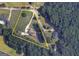 An aerial view of the property with a circular drive that leads to the front and detached garage at 2204 Happy Hollow Se Ct, Conyers, GA 30094
