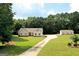 House and detached garage viewed from above, showing ample yard space and driveway at 2204 Happy Hollow Se Ct, Conyers, GA 30094
