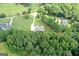 High-angle aerial view of the property with lush trees surrounding the well-maintained house at 2204 Happy Hollow Se Ct, Conyers, GA 30094