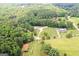 Expansive aerial view of the property showcasing the house and the surrounding lush greenery at 2204 Happy Hollow Se Ct, Conyers, GA 30094
