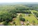 Wide aerial shot of the property, highlighting the home's setting amidst natural landscape at 2204 Happy Hollow Se Ct, Conyers, GA 30094