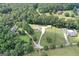 Expansive aerial view showing the house, garage, long driveway, and landscape at 2204 Happy Hollow Se Ct, Conyers, GA 30094