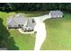 An aerial view showcasing the home, driveway, and expansive green yard at 2204 Happy Hollow Se Ct, Conyers, GA 30094
