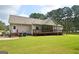 Lovely rear exterior with inviting deck, porch, and well-maintained lawn at 2204 Happy Hollow Se Ct, Conyers, GA 30094